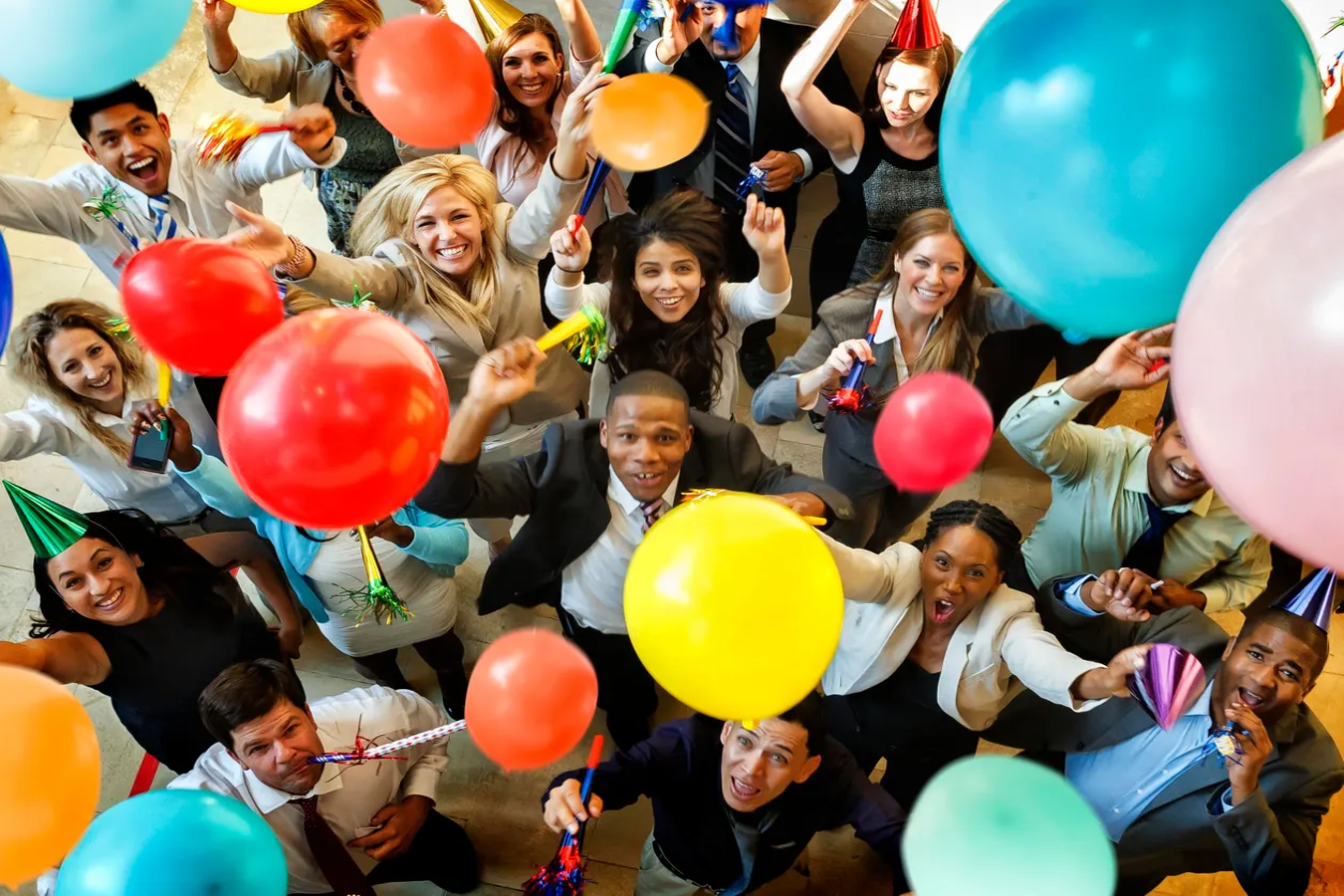 A joyful group of friends holding colorful balloons at a party, visualizing the image to audio AI process for celebrations.