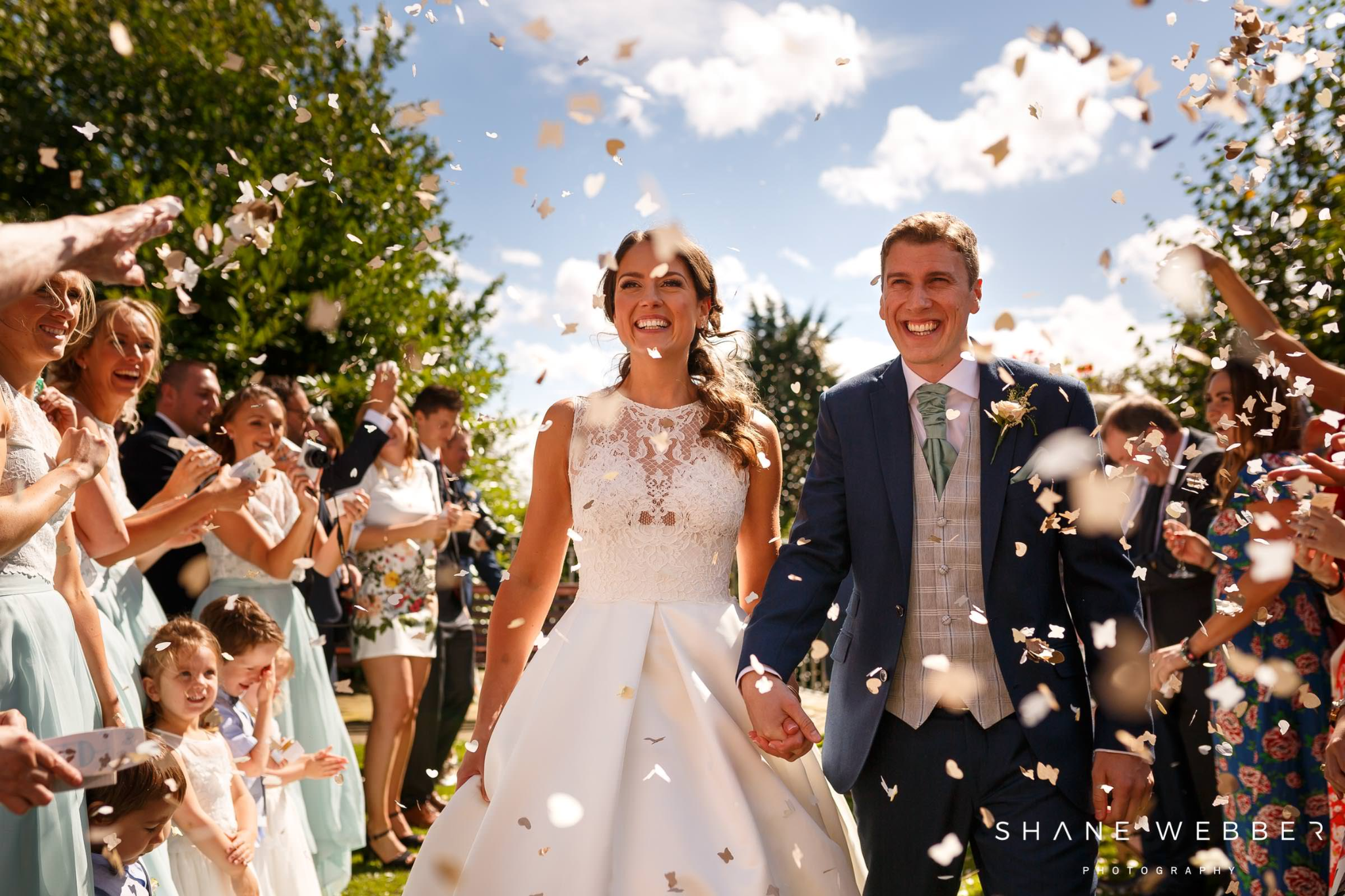 Bride and groom running through confetti, creating a melody with image to audio AI.