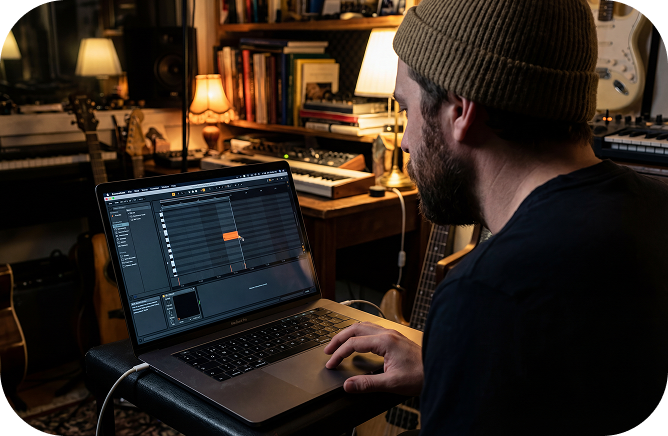 A creative individual sitting in a cozy study, using a Photo Video Maker with Music to compile a visual story with his guitar melodies